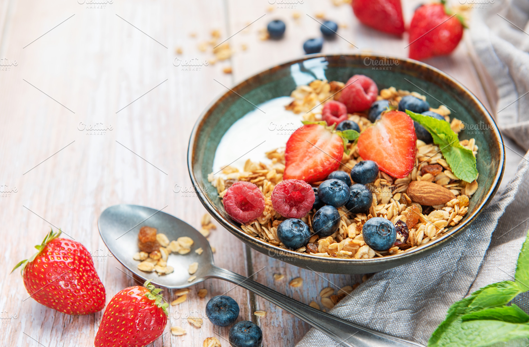 Healthy breakfast bowl with granola and fresh berries, a Food & Drink Photo by Olena Rudo