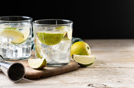 Glass of vodka tonic cocktail on wooden table, a Food & Drink Photo by etorres69