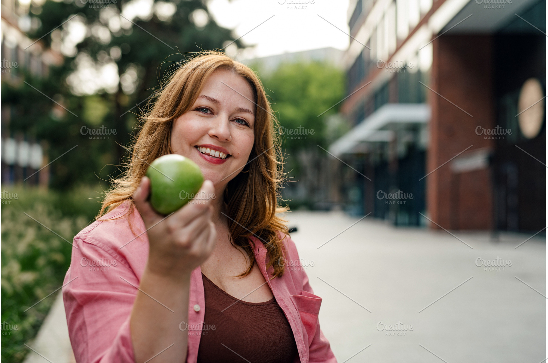 Plus size woman holding green apple., a Person Photo by HalfPoint