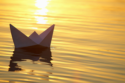 Paper boat sailing on water