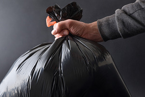 Detail of hand with garbage bag and isolated black background, a Nature Photo by Davizro's Market