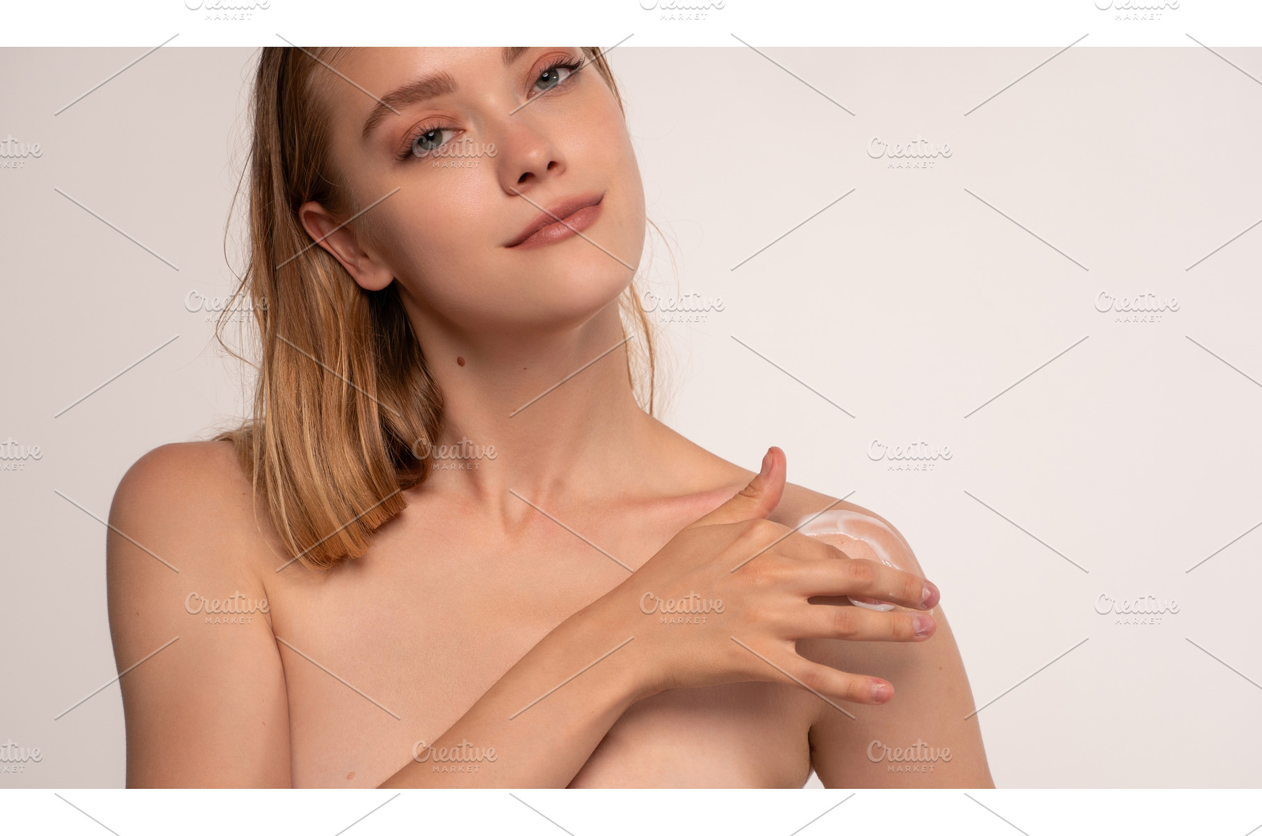 Young woman applying body lotion on, a Beauty & Fashion Photo by volodymyrshtun13795