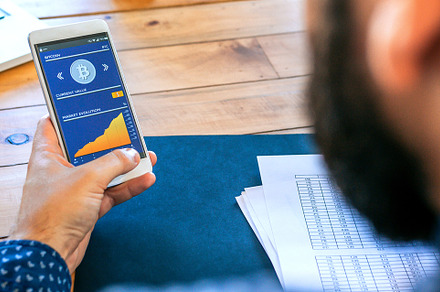 Businessman looking mobile with bitcoins information, a Business Photo by davidpereiras