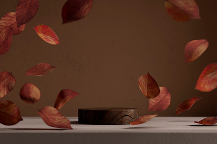 Natural wood podium with falling autumn leaves in front of beige