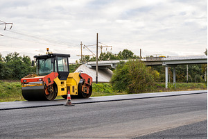 Road roller near bridge during, an Industrial Photo by volodymyrshtun13795