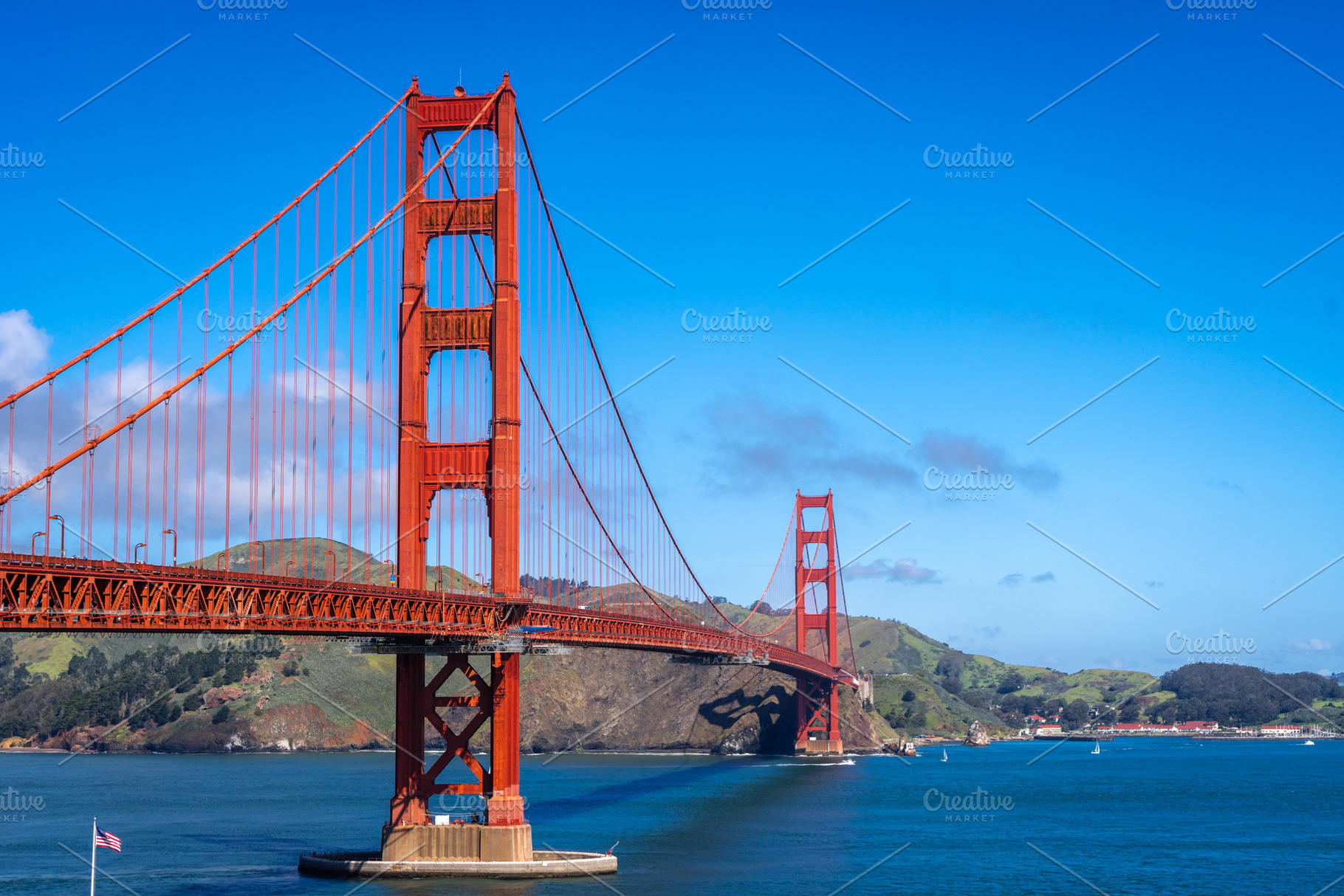 Golden Gate Bridge over blue waters with scenic hills in San Fra, a Photo by GoodGoods