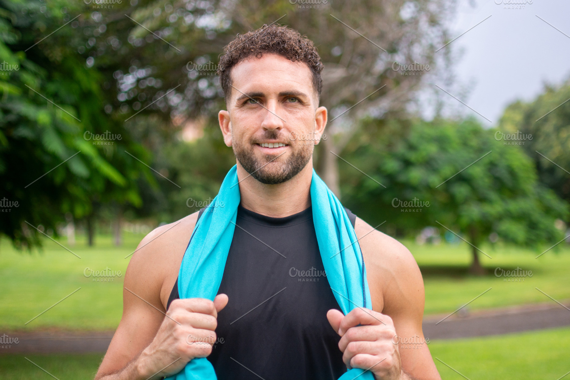 Smiling athletic man resting after fitness workout in green park, a Photo by etorres69