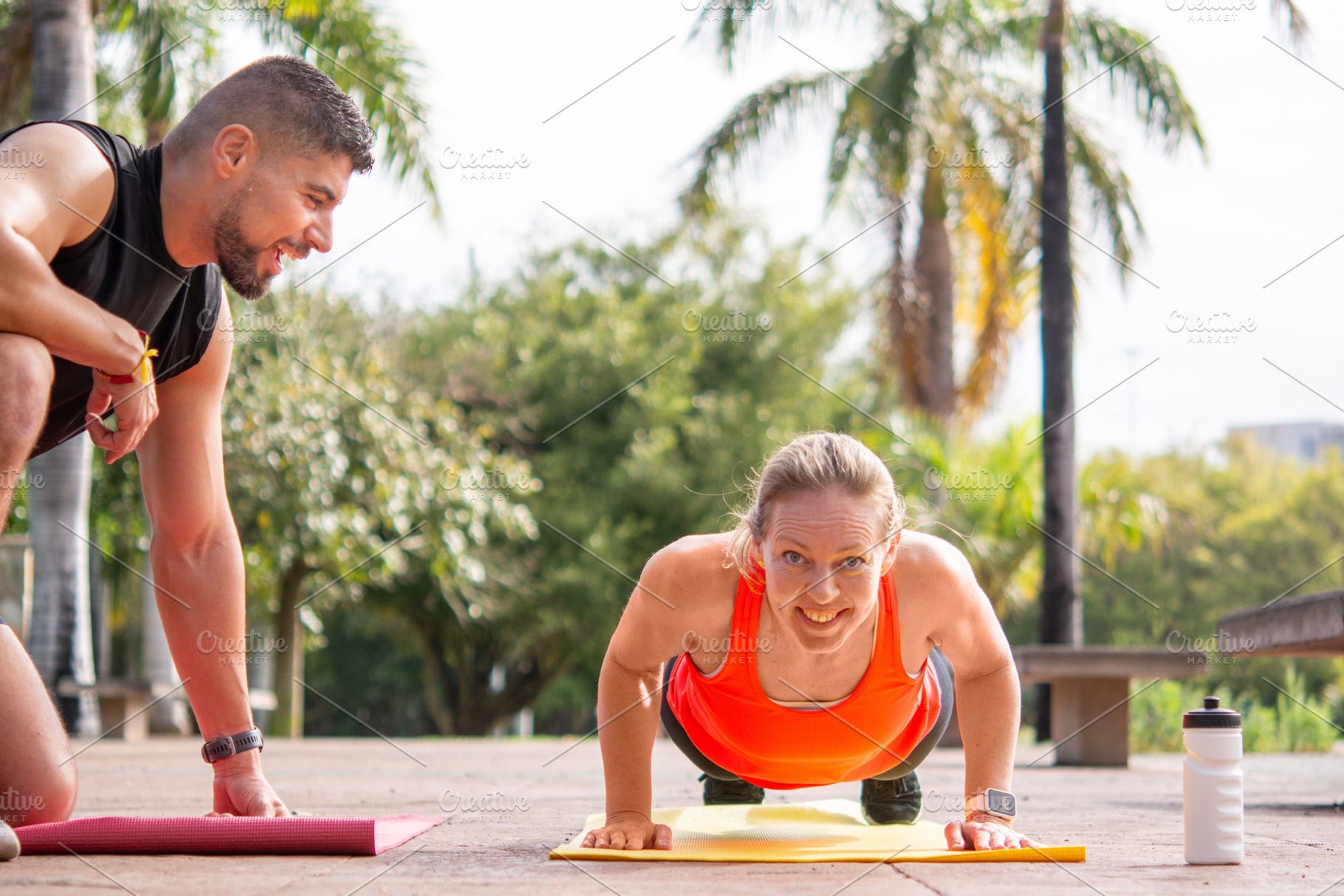 Personal Trainer Coaching Woman During Outdoor Push-Up Workout, a Sports & Recreation Photo by etorres69