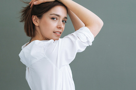 Young woman on grey background, a Person Photo by Galina_Zhigalova