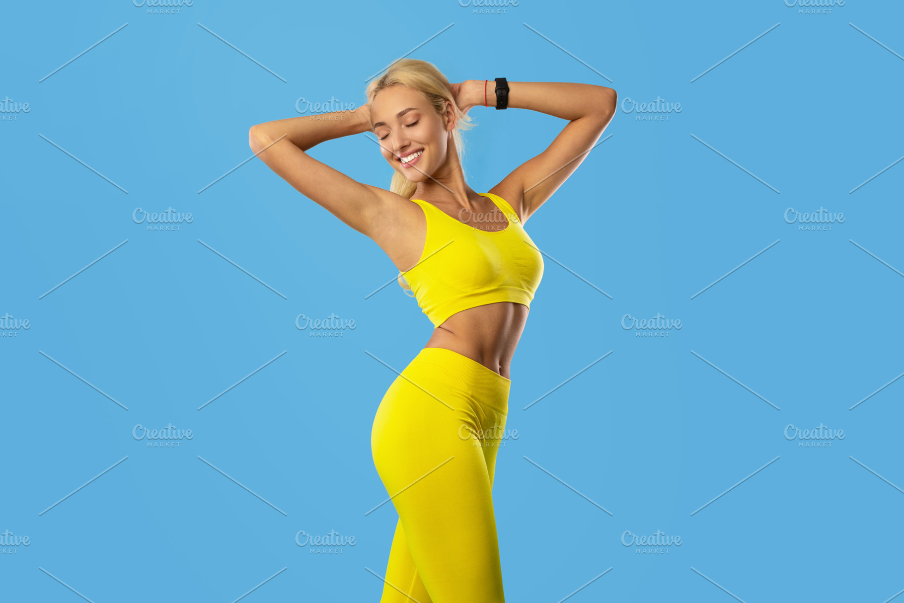 Smiling Sporty Woman Posing Isolated On Blue Background, a Photo by Prostock-Studio
