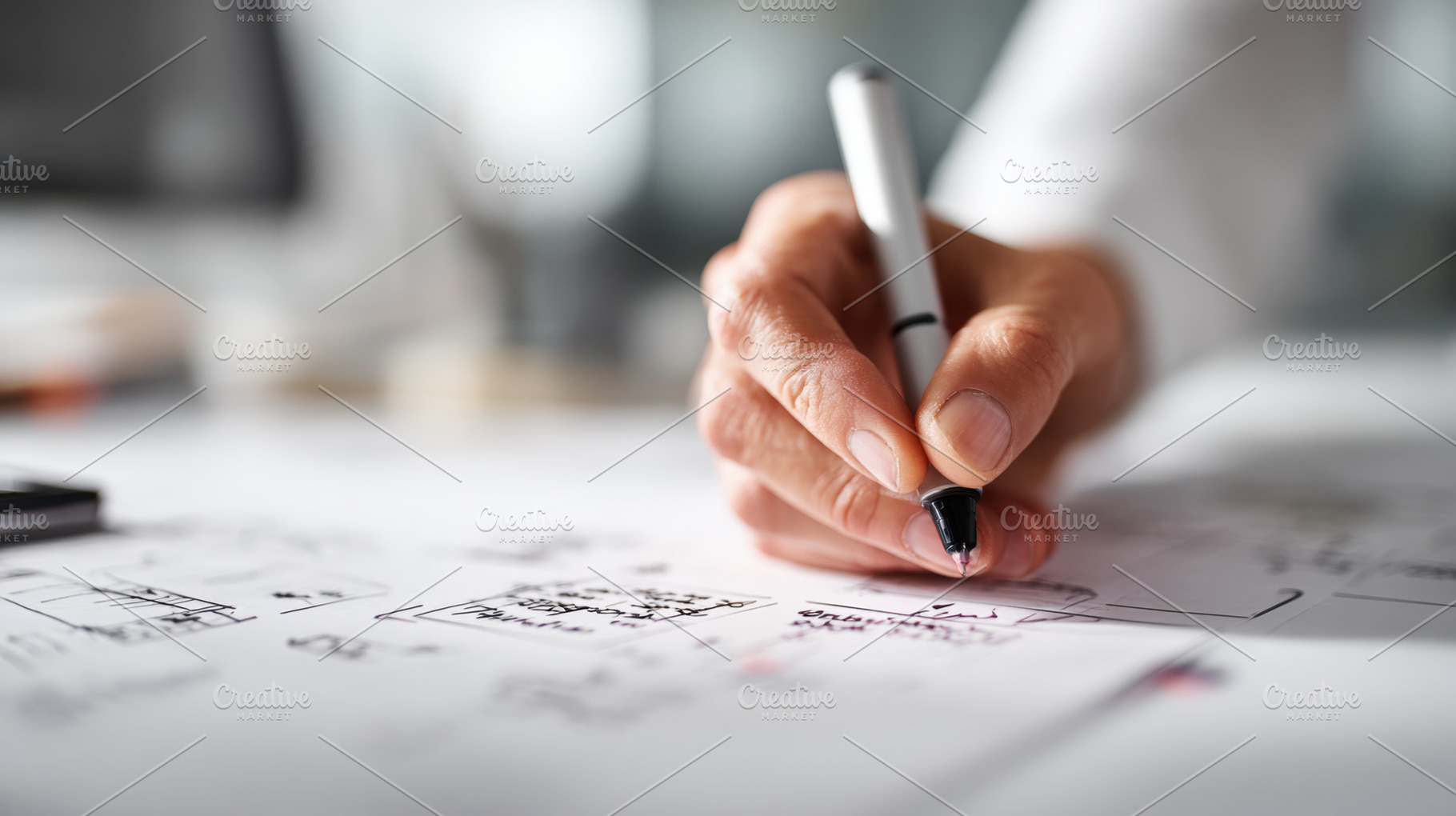 Hands drawing plans at a desk, a Photo by Beautiful things