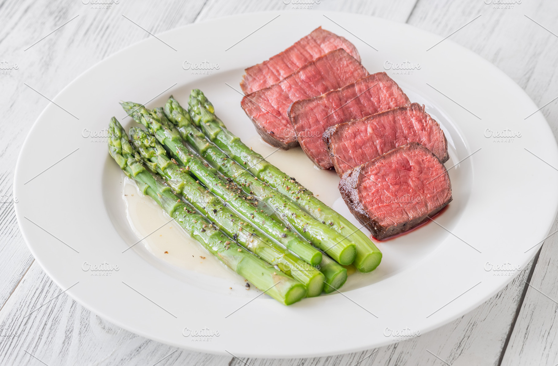 Juicy Medium Rare Steak Served With Asparagus And Lemon Butter S, a Food & Drink Photo by Alexander Prokopenko