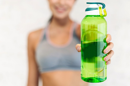 Portrait sport beauty body slim woman drinking water from a bott