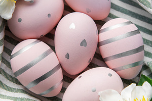 Pink easter eggs with silver patterns and spring flowers, a Holiday Photo by Olena Rudo