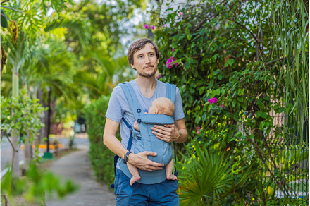 Young father walks in nature with
