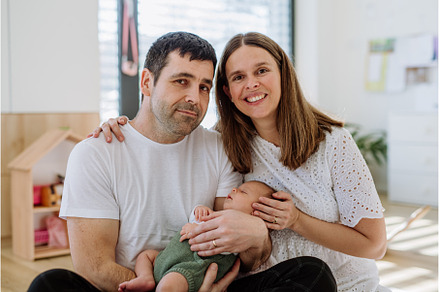 Happy parents cuddling with their, a Person Photo by HalfPoint
