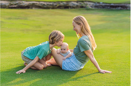 Mother, older son, and newborn baby