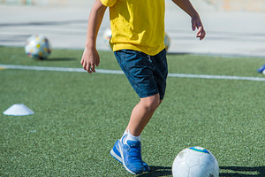 Young football player in a training containing football, soccer, and training