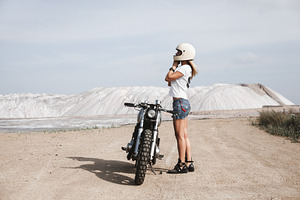 Sexy girl biker and cafe racer motorcycle containing wheels, motorcyclist, a Transportation Photo by Aliaksei Kaponia
