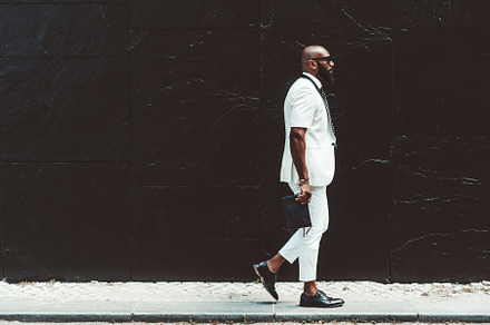 A black man in a white costume, a Person Photo by SkyNext