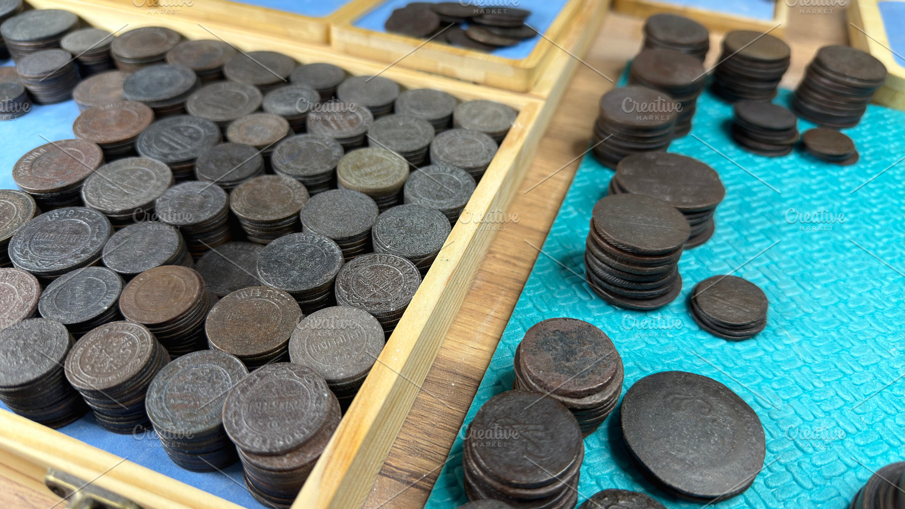 A collection of old Russian Empire coins arranged in wooden trays, some stacked, an Industrial Photo by Textures & Backgrounds