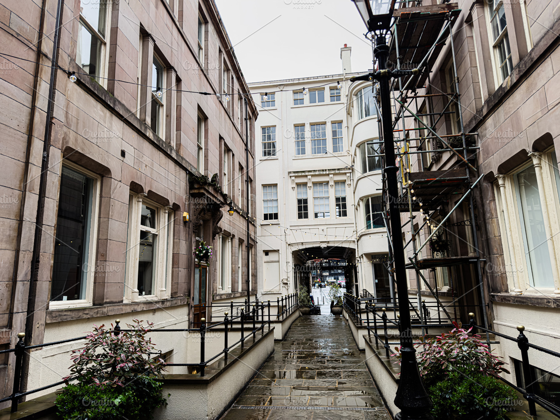 Wet narrow street and historic architecture in Liverpool, UK with stone buildin, a Photo by AS photostudio