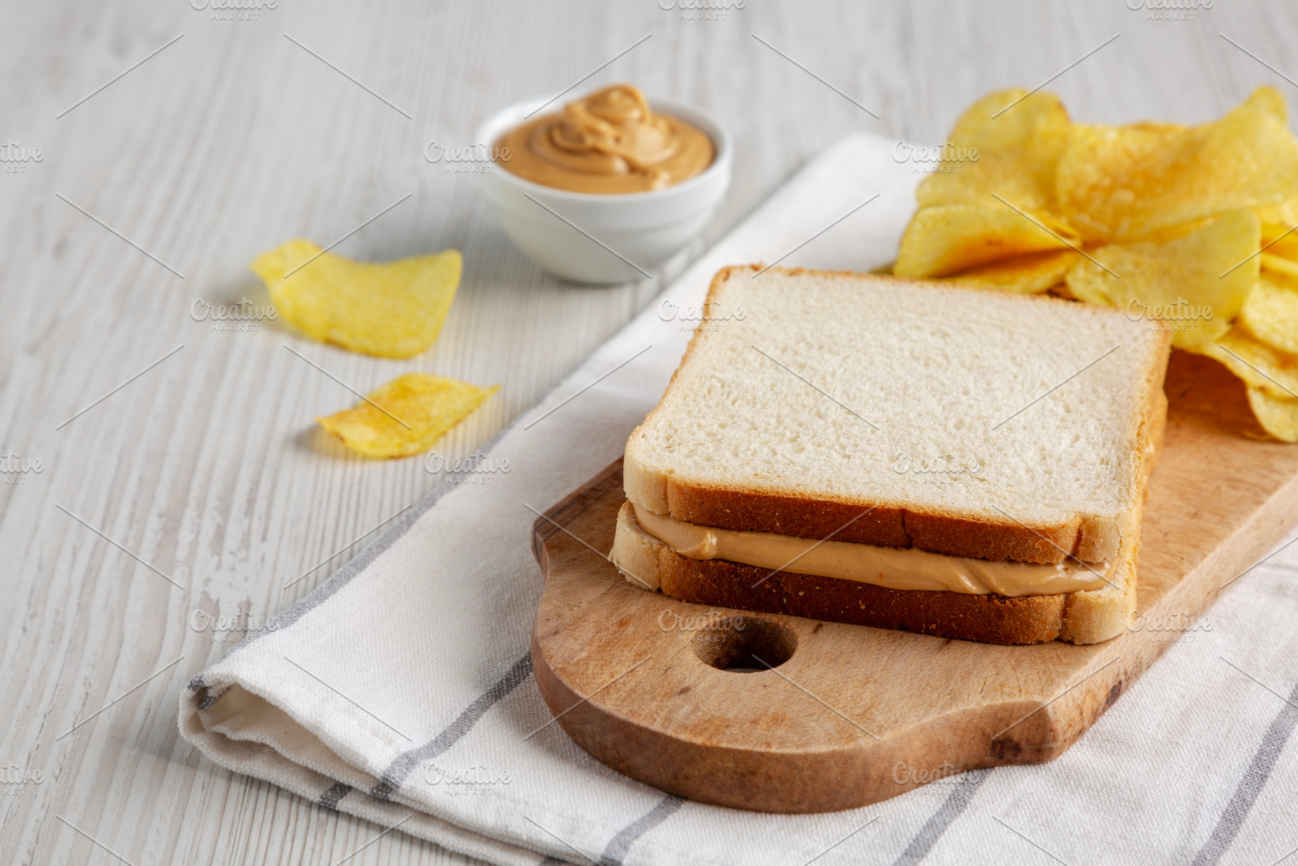 Homemade American Peanut Butter Sandwich and Potato Chips, side, a Food & Drink Photo by LiudmylaChuhunova