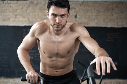 Man using exercise bike at the gym, a Sports & Recreation Photo by OPOLJA