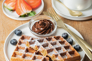 Belgium waffles Homemade waffles with strawberries, a Food & Drink Photo by Budarinphoto