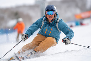Man skiing joyfully on snowy slope, a Sports & Recreation Photo by AlyaAnd