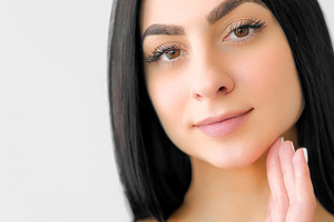 Healthy skin makeup routine woman caressing face, a Person Photo by Photo Drive Studio