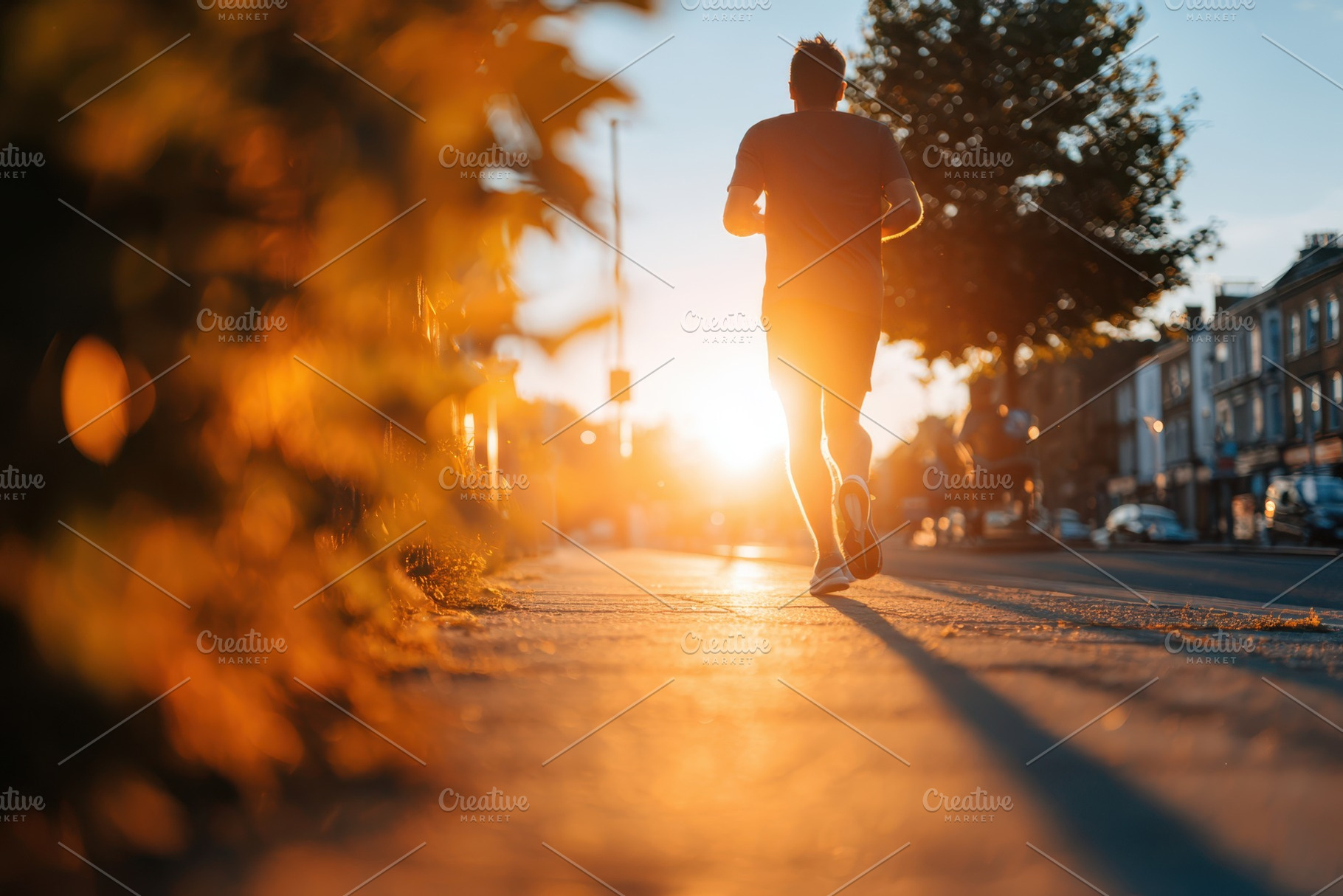 Runner silhouette at sunset on city street, a Sports & Recreation Photo by AlyaAnd