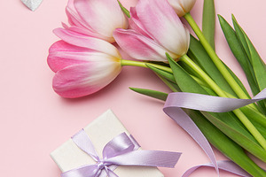 Pink tulips and gift box on pink background for mother's day or, a Holiday Photo by Olena Rudo