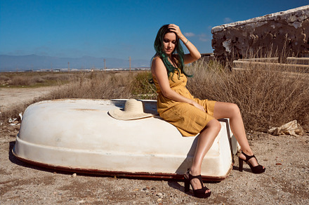 a girl sitting on a boat stranded in a summer landscape, a Beauty & Fashion Photo by YossSabalet
