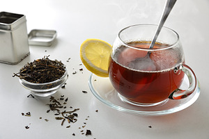 Black tea with lemon on white table elevated view, a Food & Drink Photo by Davizro's Market