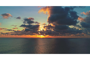 Sun setting over calm ocean with, a Nature Photo by Goinyk