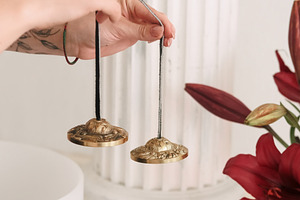 Tingsha bells sound meditation hand, a Person Photo by Photo Drive Studio