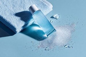 Skincare bottle with refreshing blue liquid, foam, ice, and soft, a Photo by Studio ANNA