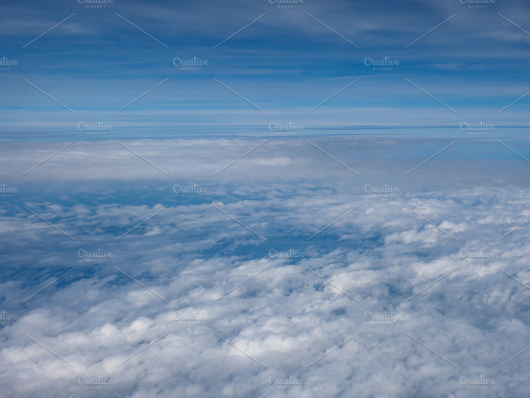 dramatic cloudy sky seen from plane background, a Photo by WorldOfPhotos