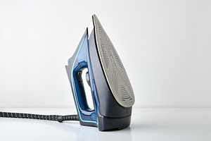 Steam iron supported vertically in a diagonal position, a Technology Photo by Davizro's Market