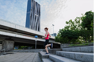 Sporty woman running down the stairs, a Person Photo by HalfPoint