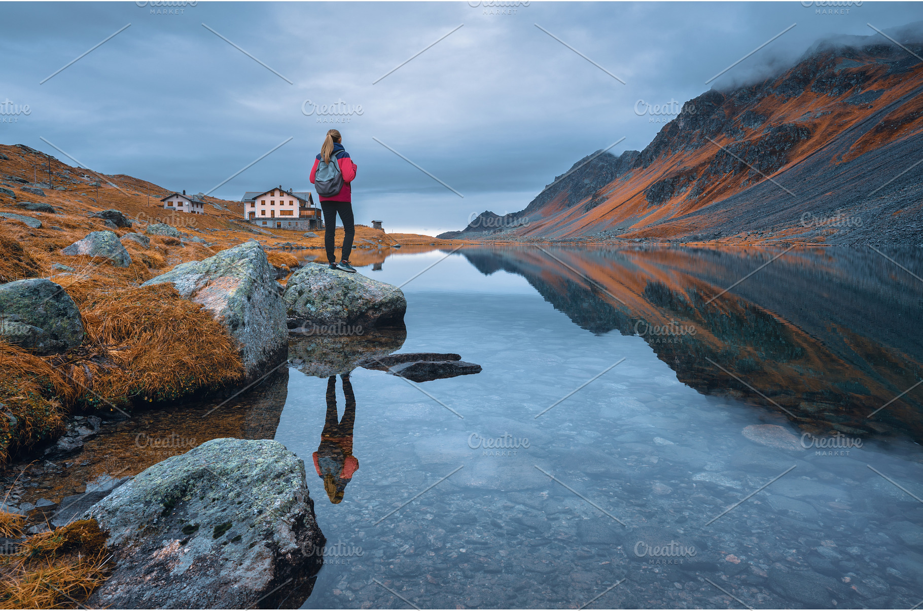 Young woman standing on a rock on, a Person Photo by den-belitsky