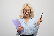 Overjoyed female entrepreneur in formal wear holding folder with documents and, a Photo by Prostock-Studio (Thumbnail 2 of 2)