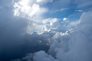 Dramatic sky with sunbeams and clouds seen from an airplane, a Nature Photo by GoodGoods