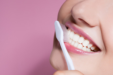 Young woman smiling with toothbrush containing adult, attractive, and