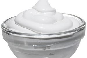 A portion of thick sour cream or yogurt in a transparent glass b, a Food & Drink Photo by ndanko