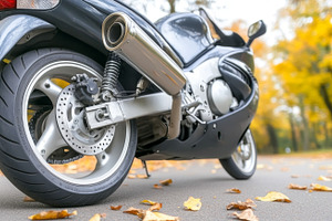 Motorcycle rear wheel close-up on asphalt road in autumn, a Photo by Dvoevnore photos