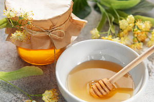 Fresh linden honey jar and bowl with dipper, a Food & Drink Photo by Olena Rudo