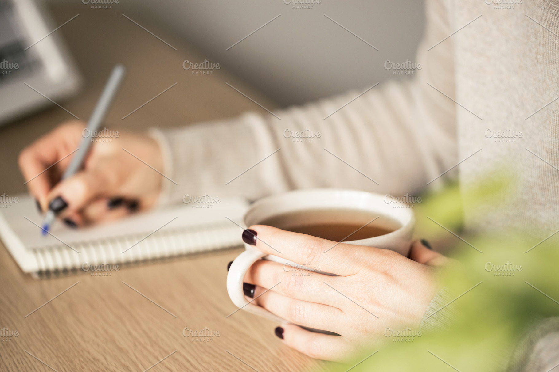 Woman holding a cup of tea, a Person Photo by Olga_Z