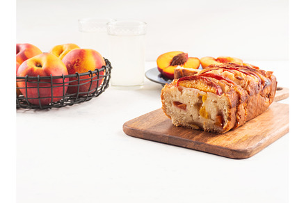 Peach cake loaf on wooden cutting